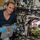 NASA astronaut and Expedition 64 Flight Engineer Kate Rubins checks out radish plants growing for the Plant Habitat-02 experiment, which aims to optimize plant growth in space and evaluate nutrition and taste of the plants.